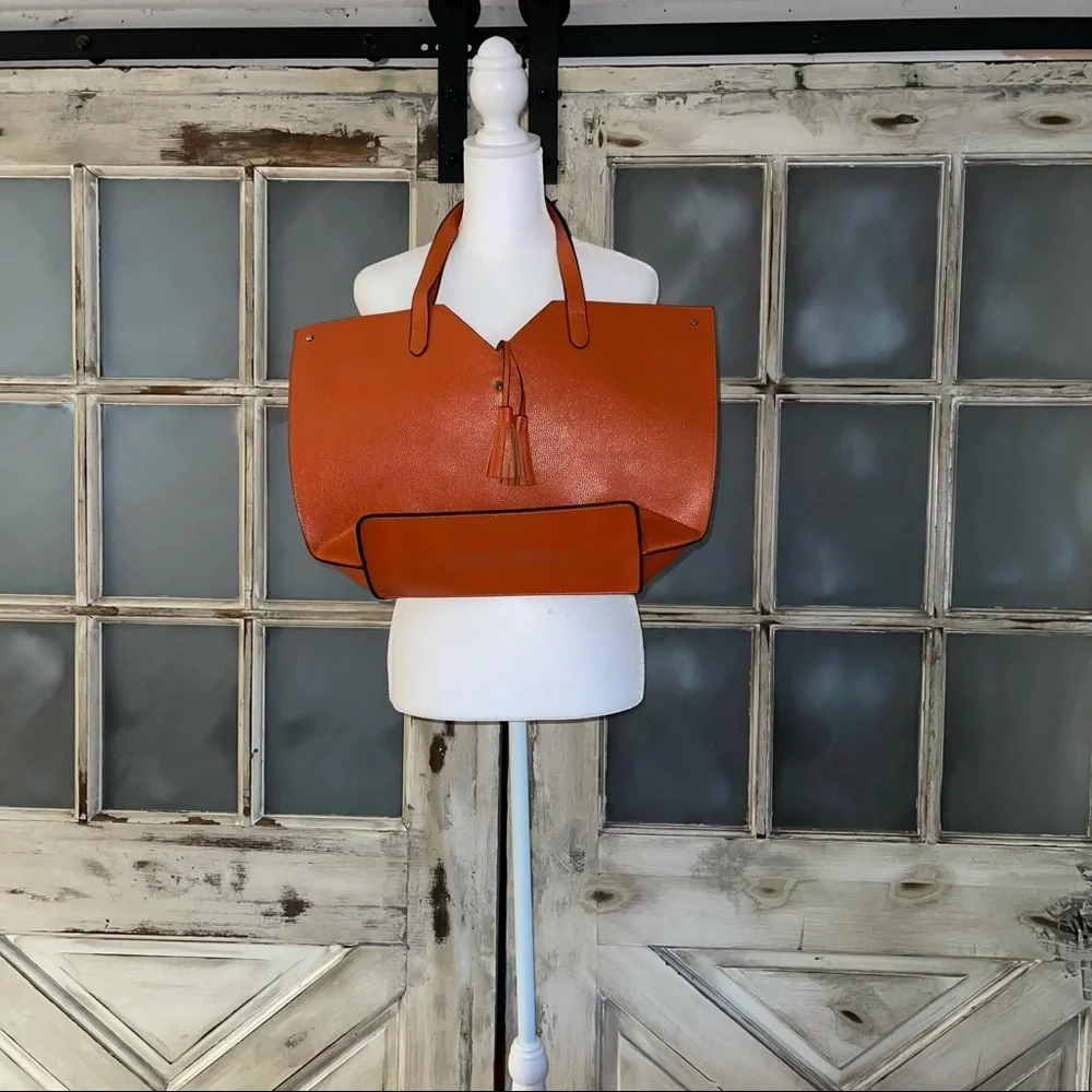 Neiman Marcus orange tote with tassel